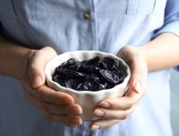 Person with a bowl on prunes