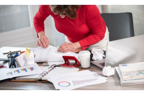 Woman with ADHD with a disorganized and messy desk