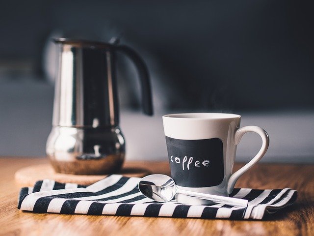 Coffee maker, mug, and spoon