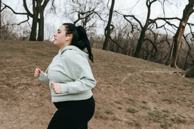 Overweight woman jogging outside